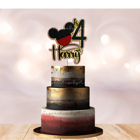 A three-tiered cake with gold and red accents and a Mickey Mouse-themed topper for a 4th birthday.