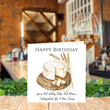 Cheese Lovers Birthday Card A birthday card featuring a cheese cake on a wooden platter.